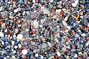 Beautiful texture of wet multicolored pebbles on the sea shore, a unique pattern for design, background, wallpaper photo